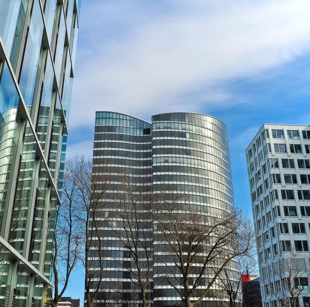 A striking view of modern skyscrapers against a clear blue sky, showcasing contemporary architectural design.